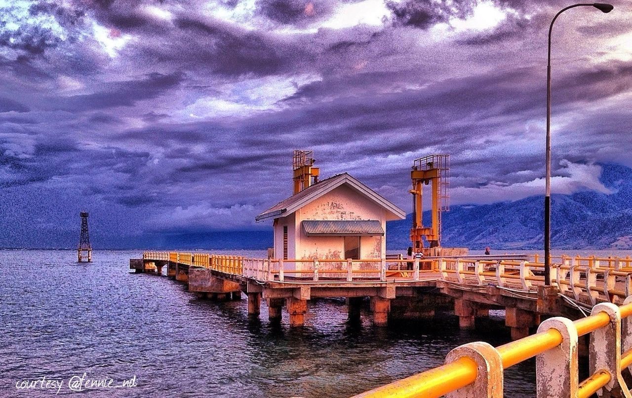 sky, water, cloud - sky, built structure, architecture, cloudy, building exterior, sea, cloud, railing, pier, street light, waterfront, nature, outdoors, overcast, river, no people, weather, tranquility