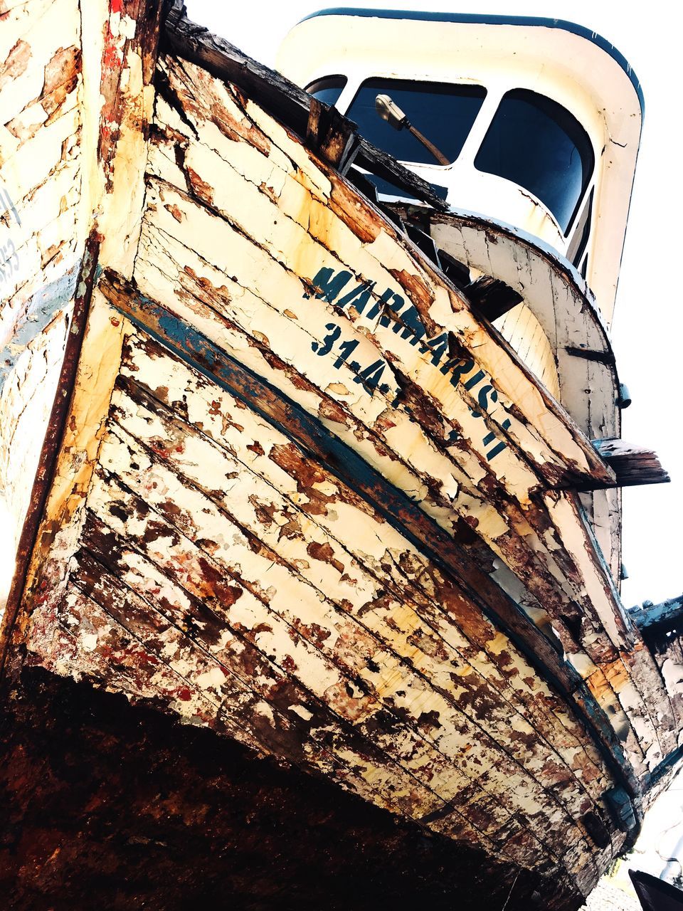 no people, day, architecture, nautical vessel, transportation, wood - material, mode of transportation, old, outdoors, abandoned, low angle view, nature, built structure, metal, damaged, rusty, weathered, building exterior, communication, ship