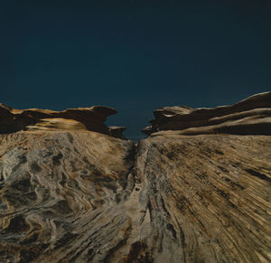 Low angle view of rock formations at night