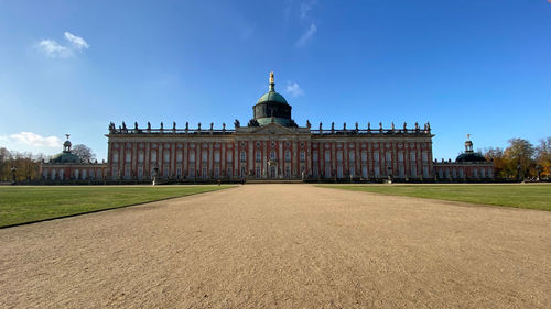 Facade of historic new palais against blue sky