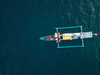 Aerial view of surfers and boat in the ocean, lombok, indonesia