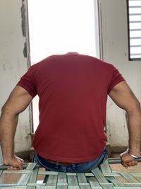 Rear view of man standing at home