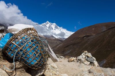 Scenic view of mountains against blue sky