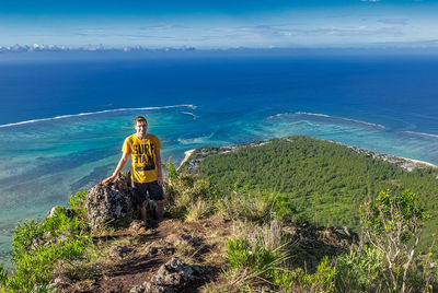 Man standing by sea against sky