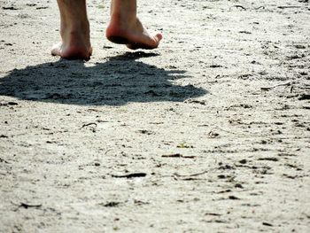 Low section of woman standing on ground