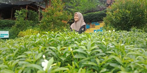 Woman sitting on plants