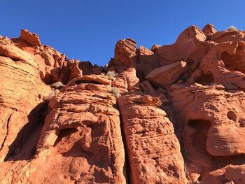 Rock formations against clear blue sky