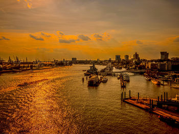 Boats in sea at sunset