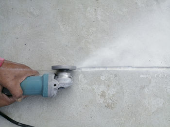 Close-up of person working on wall