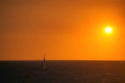 Scenic view of sea against orange sky