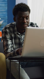 Young man using laptop at home