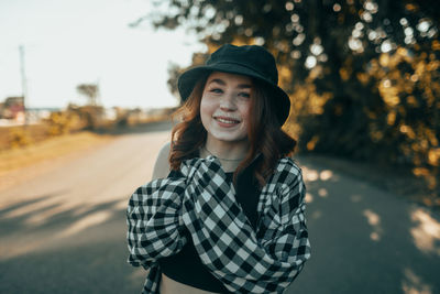 Portrait of young woman standing outdoors