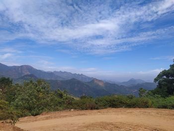 Scenic view of mountains against blue sky