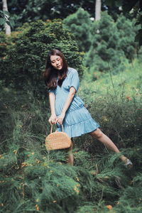 Young woman smiling while standing on field