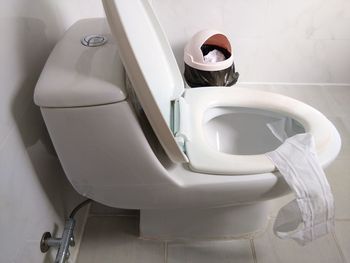 High angle view of man sitting in bathroom