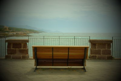 Empty bench against the wall