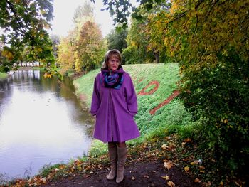 Portrait of a smiling girl standing in autumn