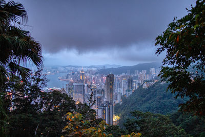 After sun set, a pathway around victoria peak at hong kong. 
buildings in city against cloudy sky