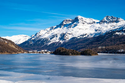 A view of lake sils and the chaste peninsula from above. panorama from grevasalvas in winter.