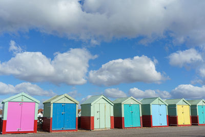 Multi colored umbrellas on beach against sky