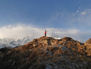 Man on rock against sky