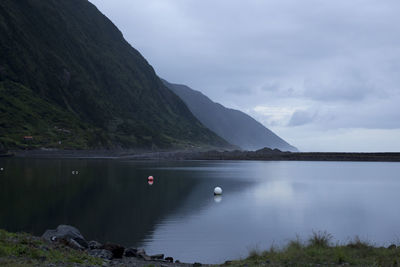 Scenic view of lake and mountains against sky