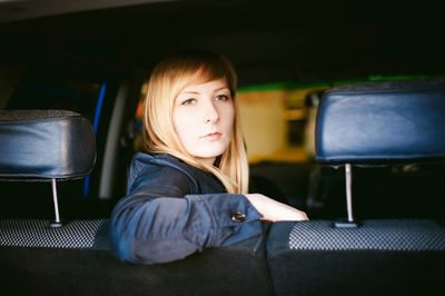 Close-up portrait of woman sitting in car