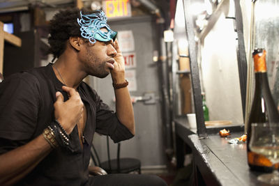 Young actor preparing backstage at a theater