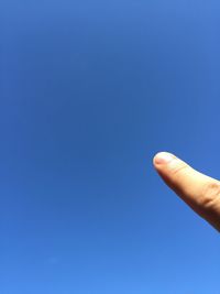 Low angle view of cropped car against clear blue sky