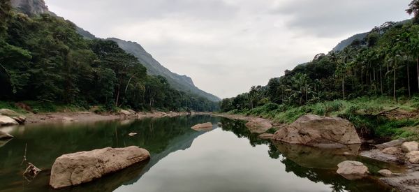 Scenic view of lake and mountains against sky