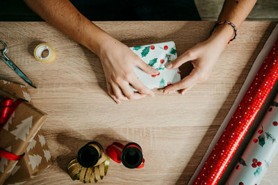 High angle view of hands on table