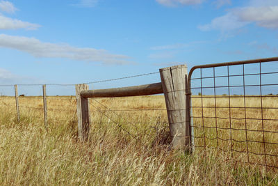 Rural fence and gate in field