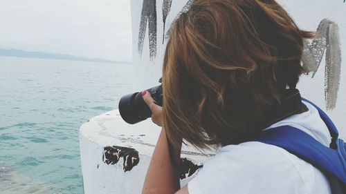 Close-up of woman photographing sea