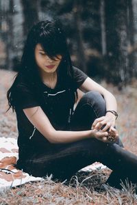 Young woman sitting on a land