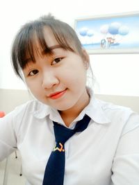 Portrait of smiling student wearing school uniform
