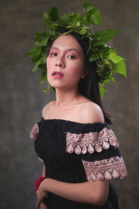 Portrait of a beautiful young woman standing outdoors