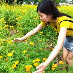 Young woman with yellow flowers