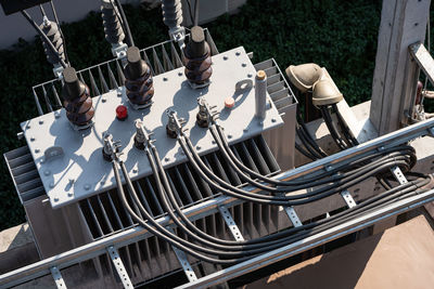 Top view of high voltage power transformer with electrical insulation in power substation.