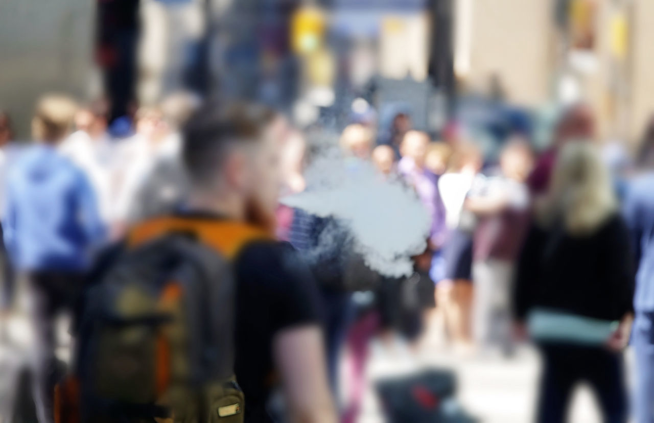 GROUP OF PEOPLE ON STREET IN CITY