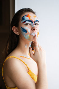 Portrait of young woman with face paint