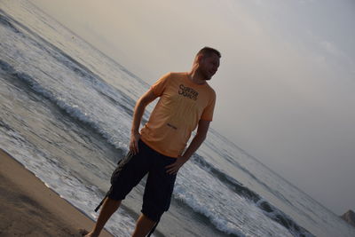 Man standing on beach against sky