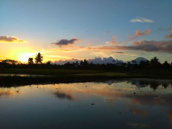 Scenic view of lake against sky during sunset