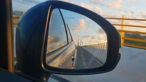 Reflection of sky on side-view mirror