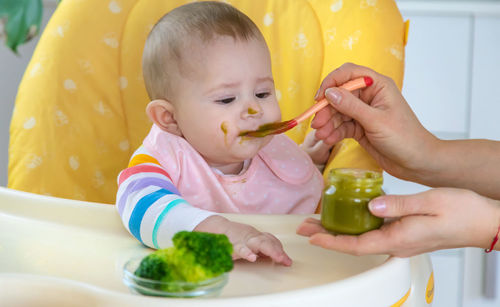 Cute girl eating food at home