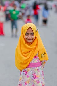 Portrait of smiling girl standing on road