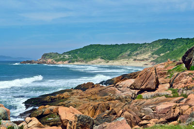 Scenic view of sea and mountains against sky