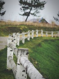 Stone wall on field against sky