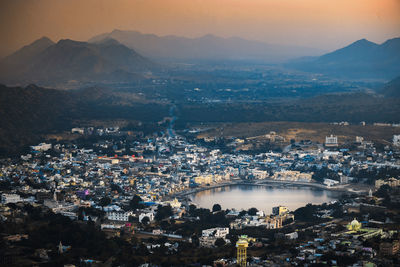 High angle view of illuminated city against sky