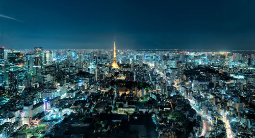 High angle view of city lit up at night