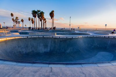 Scenic view of swimming pool against sky during sunset